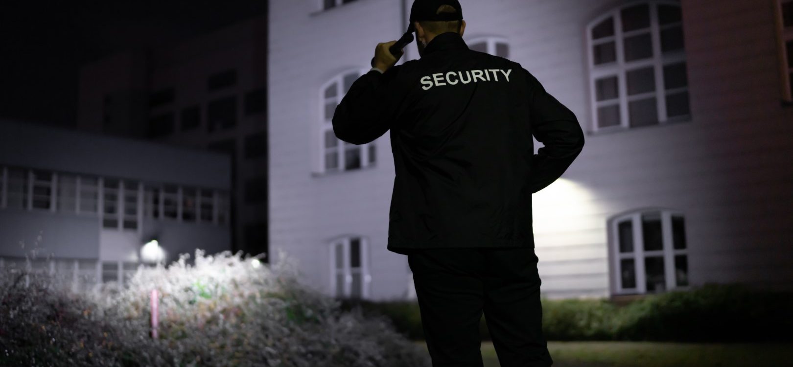 Security Guard Patrolling Premises at Night